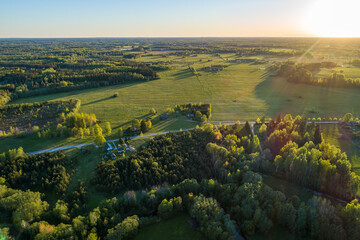 Naklejka premium Aerial view of amazing sunset at summer season. Nature landscape. Fields, rivers and trees.