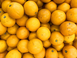 Orange fruit background. Fresh fruit in market. Close-up photo of orange.