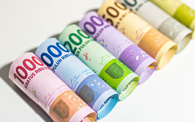 Various paper money of Indonesian rupiah in roll. Concept of investment, saving, and economic
