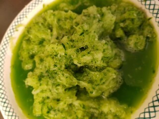 mashed cucumber in a bowl for making tzatsiki