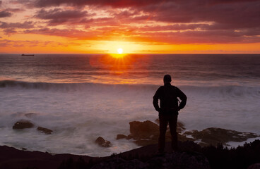 Man watching the sunset over the sea.