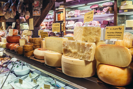 Interior of food store with cheese for sale on covered indoor food market Mercato di Mezzo in historic part of Bologna city, Italy