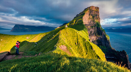 Photographer takes picture of Kallur Lighthouse, Kalsoy island. Incredible summer scene ofFaroe...