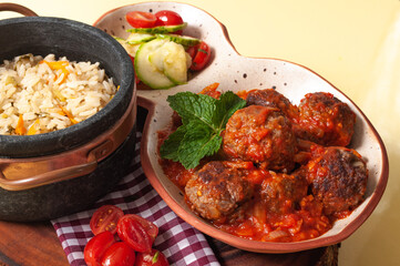 delicious meatballs with tomato sauce and salad