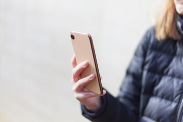 Female person with modern smartphone in hand taking pictures selective focus instagram social media communication range lifestyle technology success no branding copy space