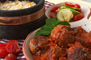 delicious meatballs with tomato sauce and salad