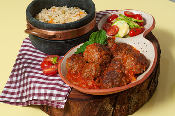 delicious meatballs with tomato sauce and salad