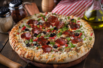 american pepperoni pizza on wooden board