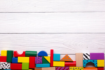 Kids educational developing toys frame on white background. Top view. Flat lay. Copy space for text