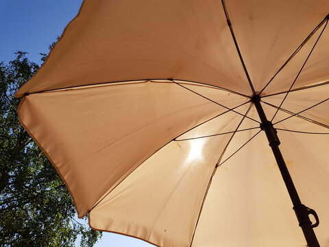 man resting on patio under parasol