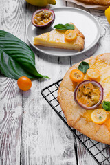 Galette with cottage cheese filling topped with kumquats, passion fruit and mint on the lattice