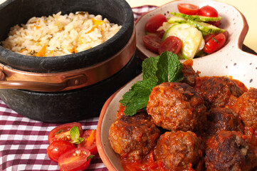 delicious meatballs with tomato sauce and salad