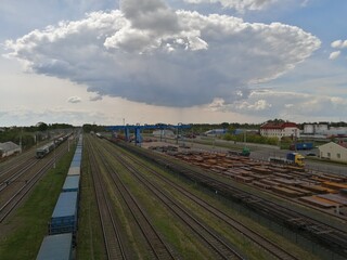 Fototapeta na wymiar rails train tracks city top view down wagons freight big cloud over the city
