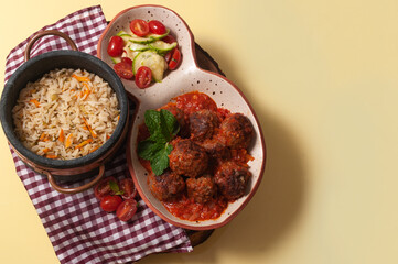 delicious meatballs with tomato sauce and salad