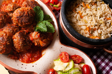 delicious meatballs with tomato sauce and salad