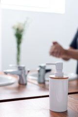 Detail of Woman's hands using soap and washing hands under the water tap