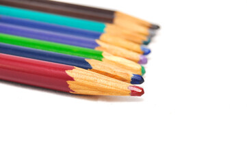 Fototapeta premium Colored pencils on a white background close up