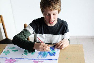 Cute 12 years old autistic boy drawing - 354677150