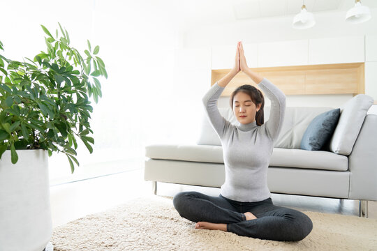 asian woman training yoga meditation at home, People stimulate mental health self care concept