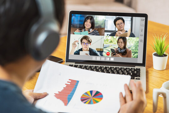 Rear View of Asian Business man presenting the data graph analyze with teamwork colleague in video conference 