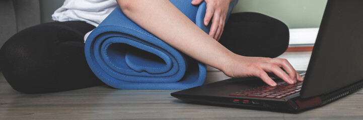 wellness at home,yoga,young girl is engaged in online training from home to quarantine in...
