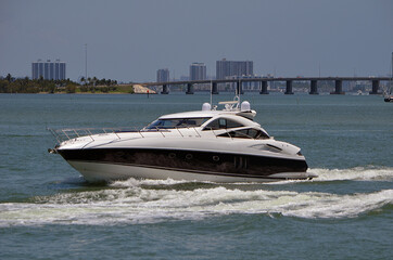 Fototapeta premium High-end cabin cruiser, white with black trim on the Florida Intra-Coastal Waterway.