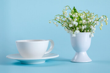 A bouquet of lilies of the valley in an egg stand