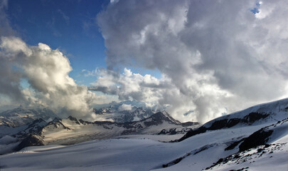 Fototapeta na wymiar Panorama of winter mountains with clouds