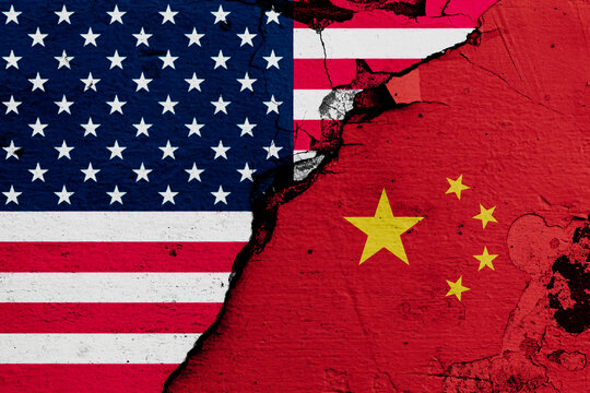 U.S.A. and China's flags on cracked wall (Concept of international conflict)