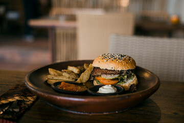 burger with fries on a table in a restaurant