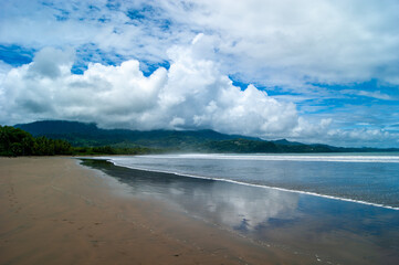 Curved Beach Below the Mountains