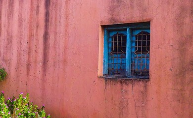 Fototapeta na wymiar old wooden blue window with green shutters