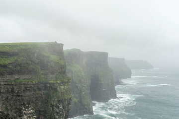 cliff of moher in ireland on rainy and foggy day
