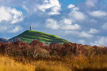 Glastonbury Tor from a distance across the wetlands of Ham Wall Nature Reserve  the browns and...