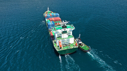 Aerial drone photo of fully loaded container cargo ship cruising in open ocean deep blue sea