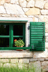 Traditional wooden window on an old stone house in Dalmatia region, Croatia. 