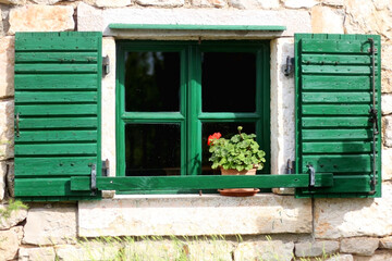 Fototapeta na wymiar Traditional wooden window on an old stone house in Dalmatia region, Croatia. 
