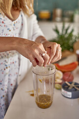 woman makes passion fruit lemonade