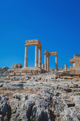 Fototapeta na wymiar The ruins of the stoa psithyros at the Lindos acropolis on the Greek island of Rhodes