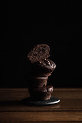 A stack of chocolate brownie cakes, low key vertical photo