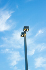 Modern lantern post against the blue sky
