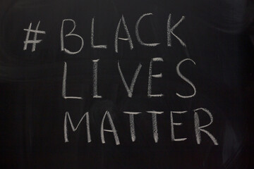 hashtag Black Lives Matter on the blackboard background.