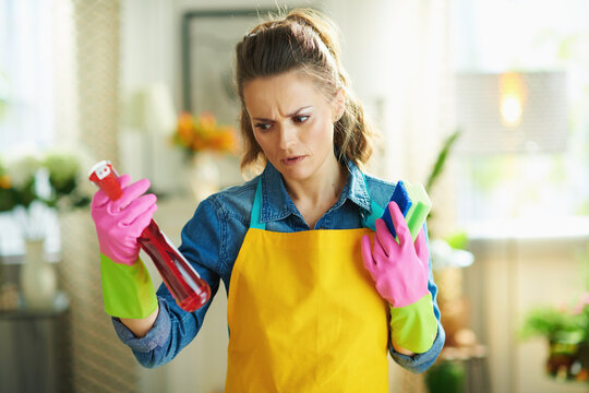 Woman With Cleaning Agent And Sponge Reading Instruction