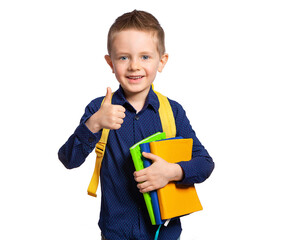 A beautiful European boy with books (notebooks) and a briefcase shows the class. Schoolboy, student, first-grader. School education, kindergarten. The student, a nerd.