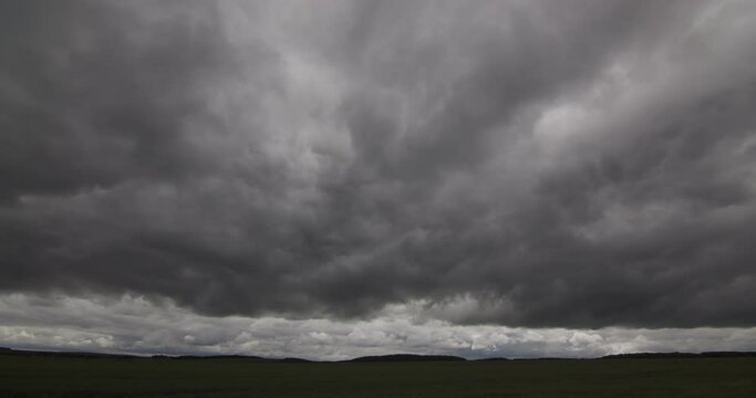 Storm clouds in a green timelapse field