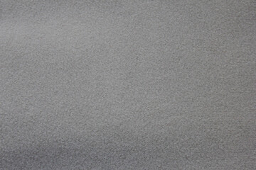 Fototapeta na wymiar Grey fabric texture background. Empty gray cloth rough surface. Blank simple seamless grey clothes background