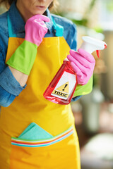 modern woman with cleaning agent reading instruction