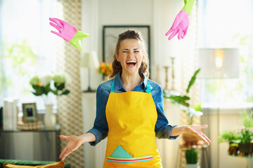 cheerful modern housewife in modern house in sunny day