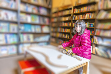 Cute young girl enjoying her time at the public library