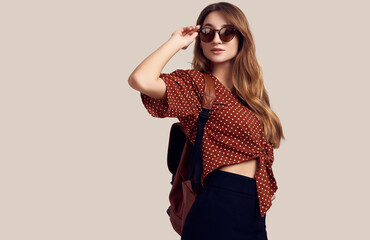 Naklejka premium Smiling student hipster girl with backpack going on a vacation